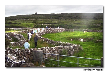 Parallel stone walls run up the mountain and serve as a path.